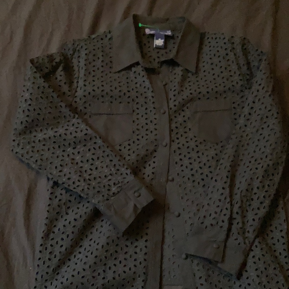Black button on long sleeve collard shirt hole pattern